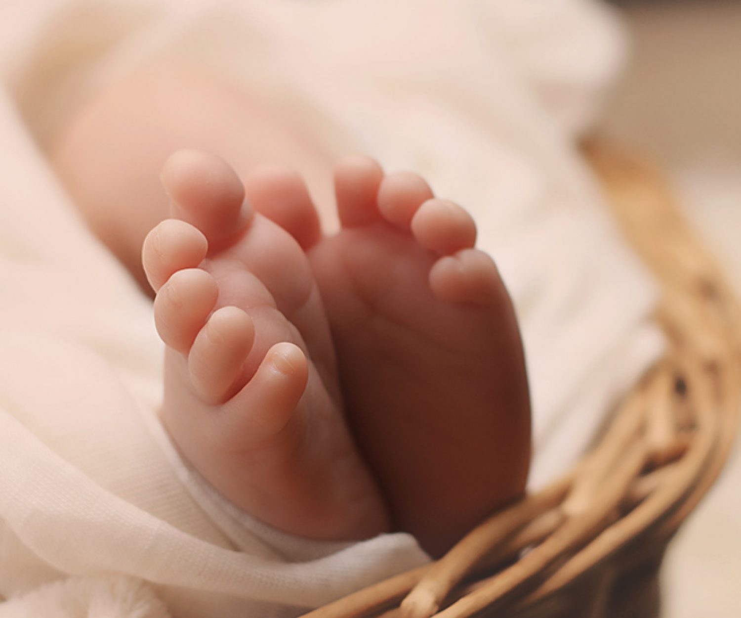 Baby's Feet on Brown Wicker Basket
