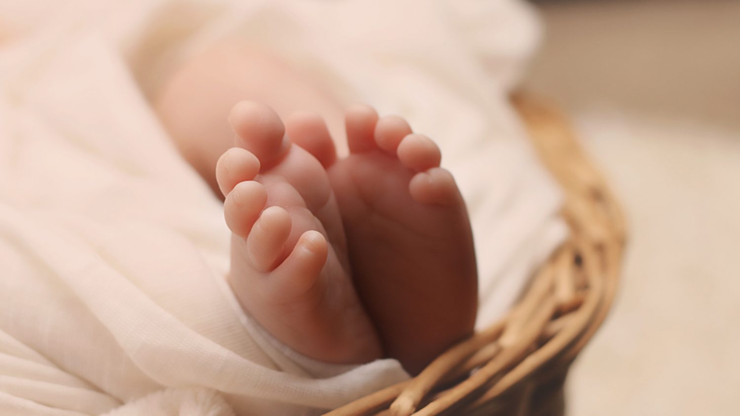 Baby's Feet on Brown Wicker Basket
